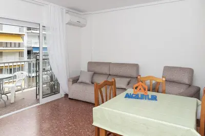 a living room with a table and a couch at ROS MARY, 7º-14 in Cullera