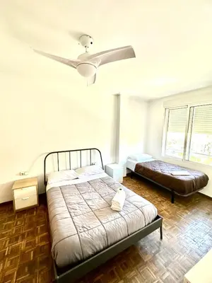 a bedroom with a bed and a ceiling fan at Rooms Valencia Center in Valencia