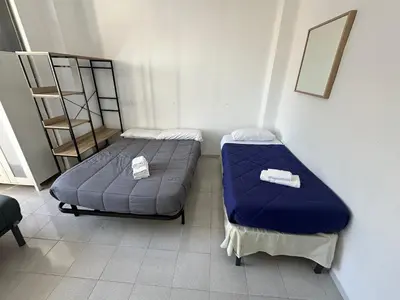 a bedroom with a bed and a desk in it at Rooms Valencia Center in Valencia