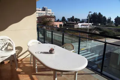 a white table and chairs on a balcony at Apartamento Playa Moncofar - Xilxes in Moncófar