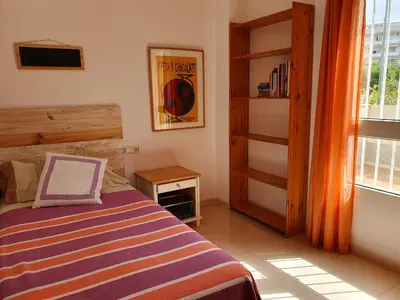 a bedroom with a bed with two towels on it at Fantastico bajo con Jardin en Playa de Canet in Canet de Berenguer