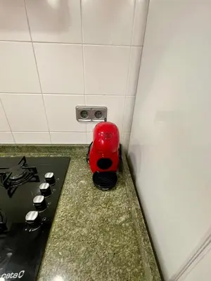 a red object sitting on a counter next to a stove at 150 Playa in Puerto de Sagunto