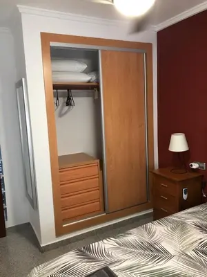 a bedroom with a closet with a bed and a dresser at 150 Playa in Puerto de Sagunto