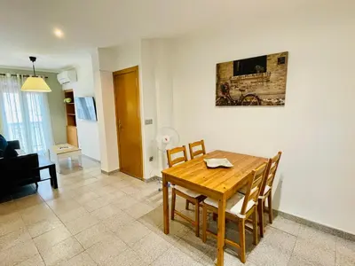a dining room table and chairs in a living room at 150 Playa in Puerto de Sagunto