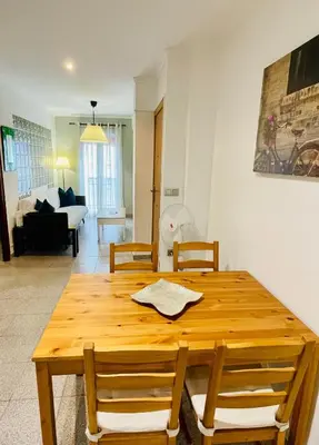 a wooden table and chairs in a living room at 150 Playa in Puerto de Sagunto