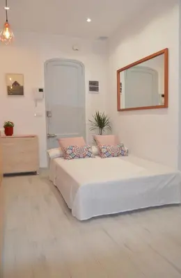 a bedroom with a bed with a mirror and a dresser at COZY & MODERN Apartment junto a Metro A Guimerá in Valencia