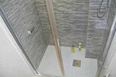 a shower with a glass door in a bathroom at COZY & MODERN Apartment junto a Metro A Guimerá in Valencia