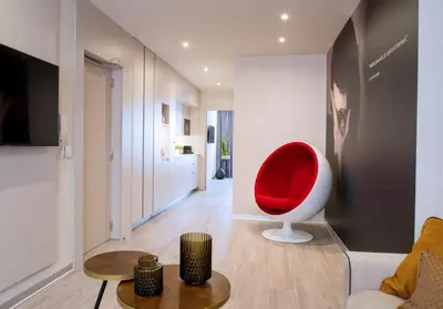 a living room with a red chair in a room at Voghe Premium Flats in Valencia