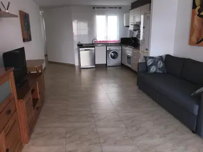 a living room with a couch and a kitchen at Apartamento Playa Grau Moncofa in Moncófar