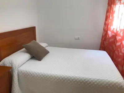 a bedroom with a bed with a pillow on it at Apartamento Playa Grau Moncofa in Moncófar