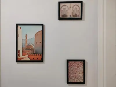 a group of framed pictures on a wall at LUJOSO apartamento- PLAYA Canet Berenguer in Canet de Berenguer