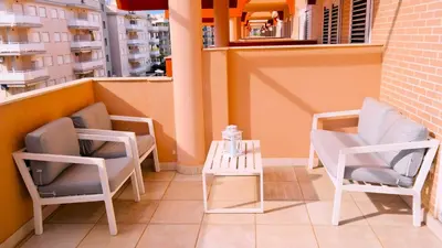 two chairs and a table on a balcony at LUJOSO apartamento- PLAYA Canet Berenguer in Canet de Berenguer
