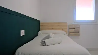 a bedroom with two beds with towels on them at LUJOSO apartamento- PLAYA Canet Berenguer in Canet de Berenguer