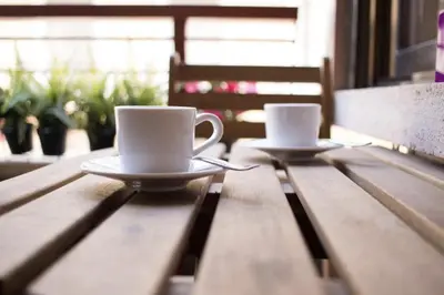 two cups of coffee sitting on a wooden table at Central Station. Free Wifi & Terrace in Valencia