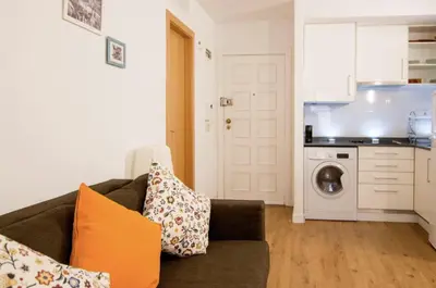 a living room with a couch and a kitchen at Central Station. Free Wifi & Terrace in Valencia