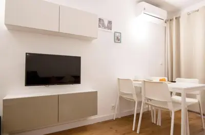 a living room with a table and a tv on a wall at Central Station. Free Wifi & Terrace in Valencia