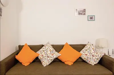 a bunch of pillows sitting on a couch at Central Station. Free Wifi & Terrace in Valencia