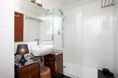a white bathroom with a sink and a shower at Comfortable Apartment in Mislata - 50 m² - Parking Included in Valencia
