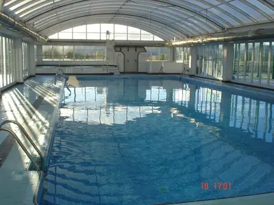 a large swimming pool in a large building at RELAX, MAR Y MONTAÑA in Tavernes de Valldigna