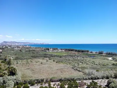 an aerial view of a field and the ocean at RELAX, MAR Y MONTAÑA in Tavernes de Valldigna