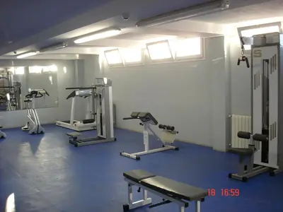 a gym with several treadmills and machines in a room at RELAX, MAR Y MONTAÑA in Tavernes de Valldigna