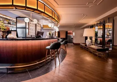 a hotel lobby with a bar and chairs at Only YOU Hotel Valencia in Valencia
