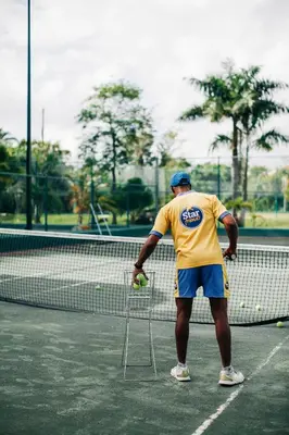 a man is standing on a tennis court at The White Apartment: Luxury, Beach and Design in Valencia