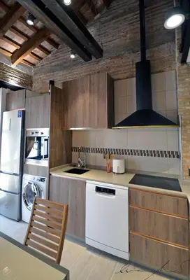 a living room with a couch and a brick wall at Casita en el Cabañal con Patio in Valencia