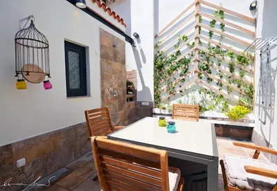 a living room with a couch and a dining room at Casita en el Cabañal con Patio in Valencia