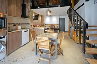 a room with two beds and a brick wall at Casita en el Cabañal con Patio in Valencia