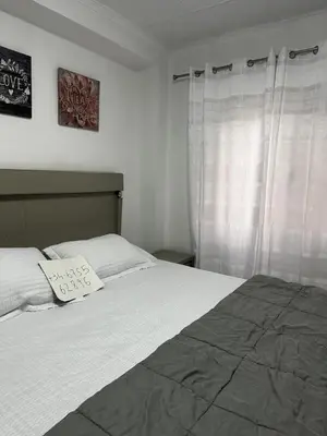 a bedroom with a bed with a pillow on it at Alquiler universidades malvarrosa Playa Maritim Valencia in Valencia