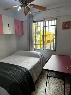 a bedroom with a bed and a ceiling fan at Alquiler universidades malvarrosa Playa Maritim Valencia in Valencia