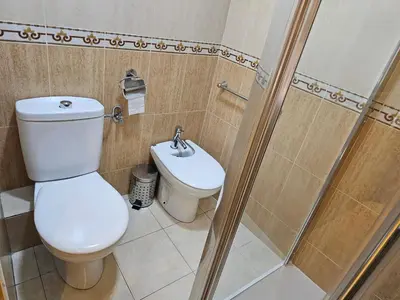 a bathroom with a toilet and a shower at Alquiler universidades malvarrosa Playa Maritim Valencia in Valencia
