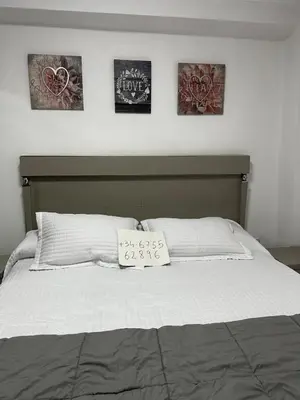 a bedroom with a bed with a sign on it at Alquiler universidades malvarrosa Playa Maritim Valencia in Valencia