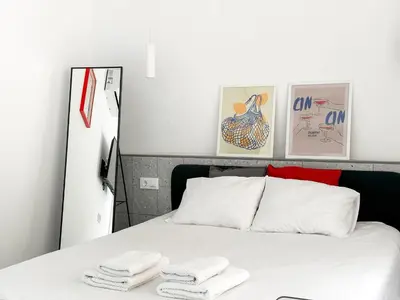 a bedroom with a bed with two towels on it at Apartamentos Navío in Valencia