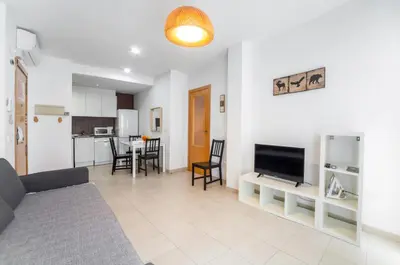 a living room with a couch and a flat screen tv at Hideout 26 in Valencia