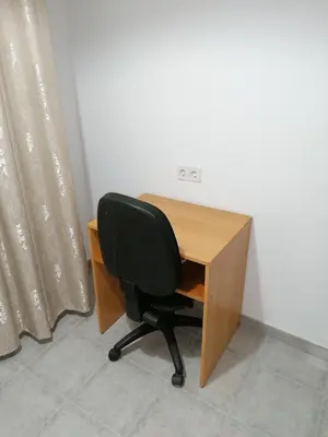 a desk with a black chair next to a wooden desk at Fully Furnished Double Room in Valencia