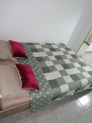 a bed with a blanket on top of it at Fully Furnished Double Room in Valencia
