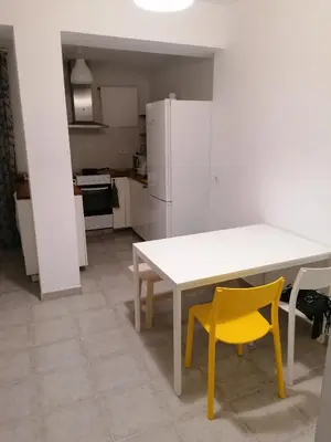 a kitchen with a white table and two yellow chairs at Fully Furnished Double Room in Valencia