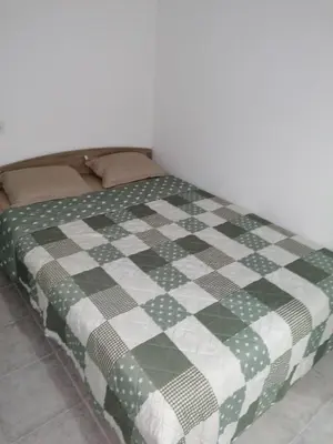 a bed with a green and white checkered blanket at Fully Furnished Double Room in Valencia