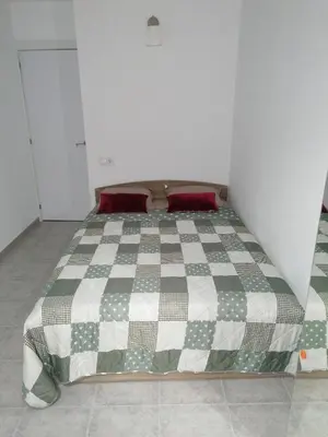 a bedroom with a bed with a checkered blanket at Fully Furnished Double Room in Valencia