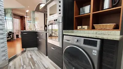 a kitchen with a washer and dryer under a counter at Terrasa de Mercado Central in Valencia