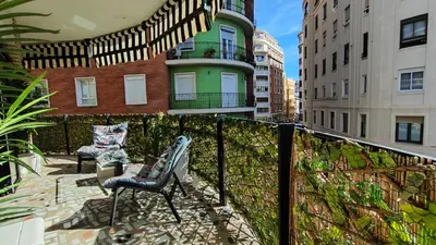 a balcony with two chairs and a fence at Terrasa de Mercado Central in Valencia