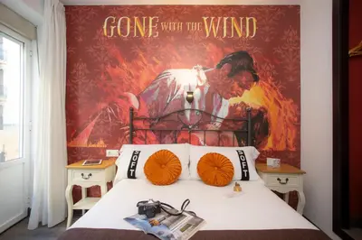 a bedroom with a bed with a poster on the wall at Casual del Cine Valencia in Valencia