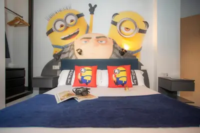 a bedroom with a bed with a mural of minions at Casual del Cine Valencia in Valencia