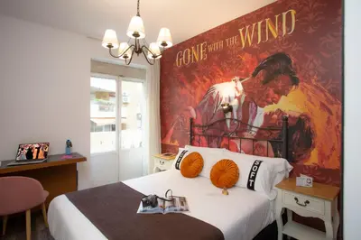 a room with a bed with a large poster on the wall at Casual del Cine Valencia in Valencia