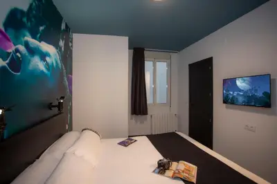 a bedroom with a bed with a camera on it at Casual del Cine Valencia in Valencia
