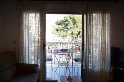 a living room with a sliding glass door to a balcony at Bonito apartament a 3 minutos de la playa in Cullera