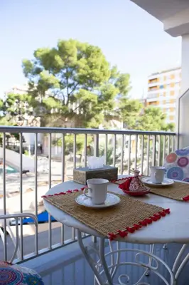 a table on a balcony with two cups of coffee at Bonito apartament a 3 minutos de la playa in Cullera