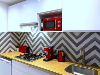 a kitchen with a red microwave above a stove at Emma Apartment Central in Valencia